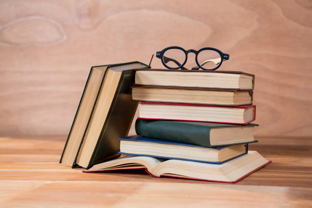various books with spectacles table