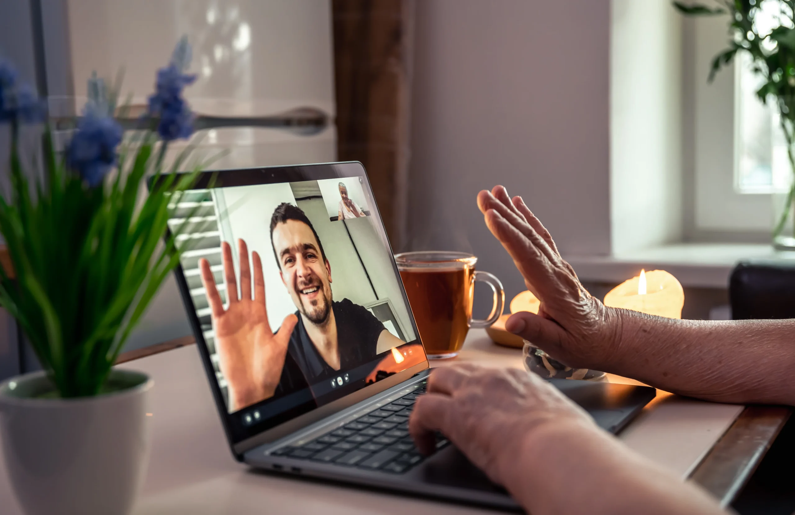old woman communicates with her son via video link through laptop scaled