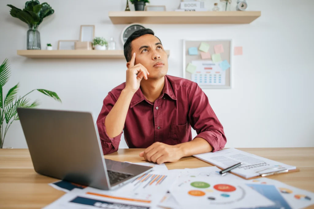 man works office thinks fixing tasks