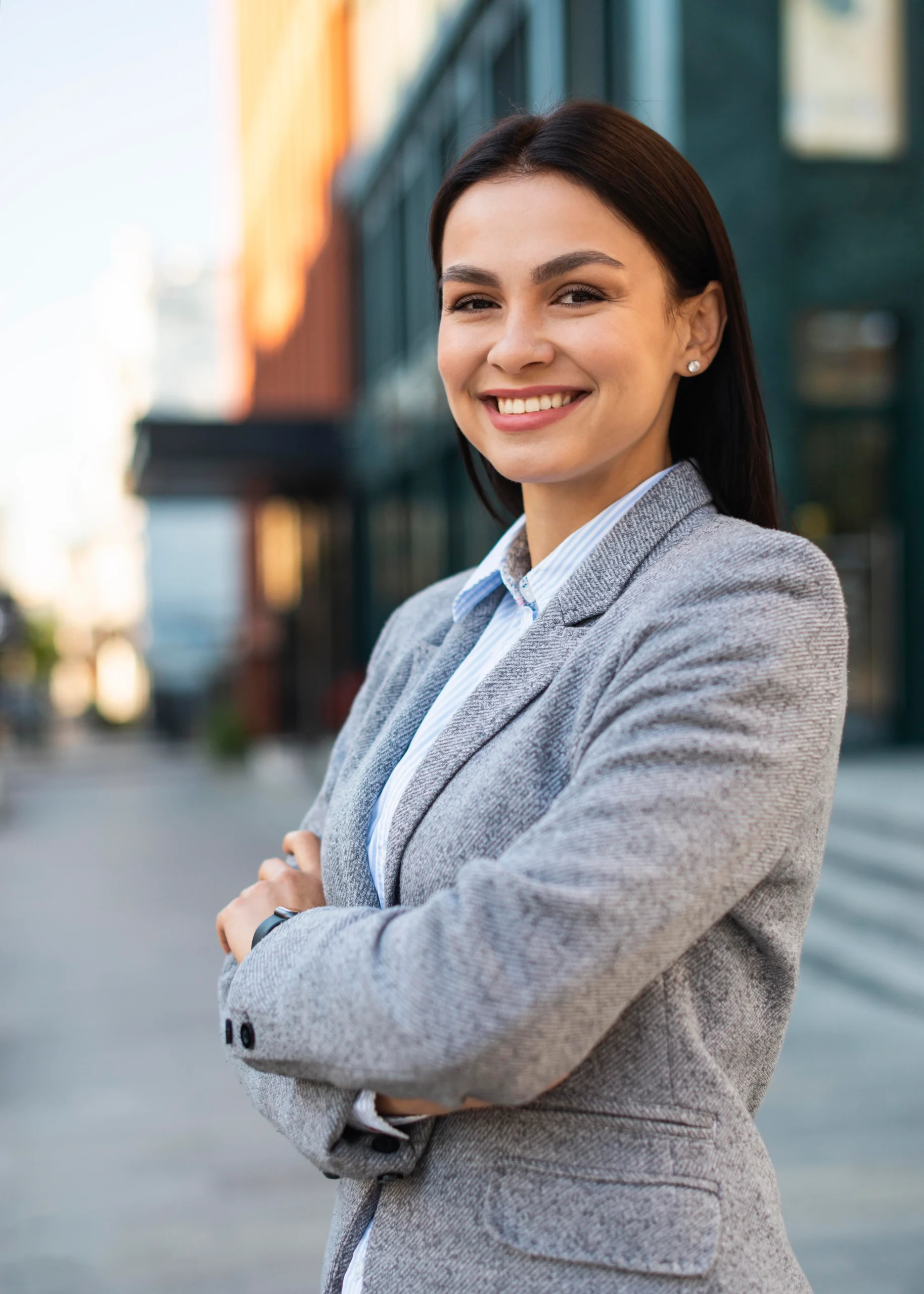 smiley businesswoman posing city with arms crossed scaled