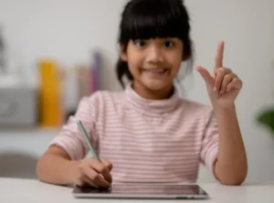 Indian child learning online spoken English with Speaking Fever, studying confidently at home.
